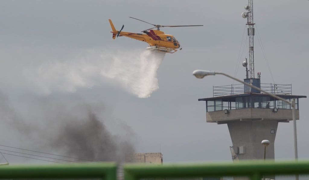 A helicopter drops water to extinguish a fire after a riot broke out at the Cadereyta state prison, in Cadereyta Jimenez, on the outskirts of Monterrey, Mexico, on Tuesday. Photo: Reuters