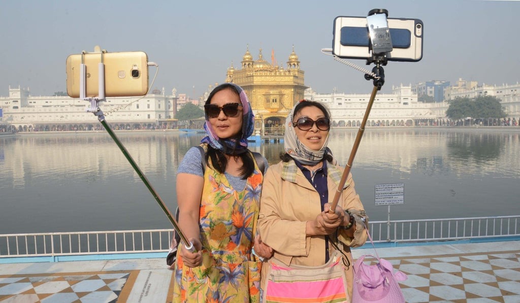 Chinese tourists take a 'selfie' at the Golden Temple in Amritsar. Photo: AFP
