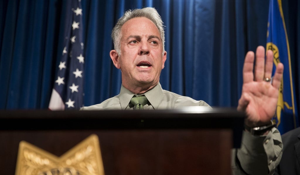 Clark County Sheriff Joe Lombardo says Las Vegas gunman Stephen Paddock shot and wounded a security guard outside his hotel room and opened fire through his door around 9.59pm – six minutes before shooting into the crowd. Photo: AP Clark County Sheriff Joe Lombardo says Las Vegas gunman Stephen Paddock shot and wounded a security guard outside his hotel room and opened fire through his door around 9.59pm – six minutes before shooting into the crowd. Photo: AP