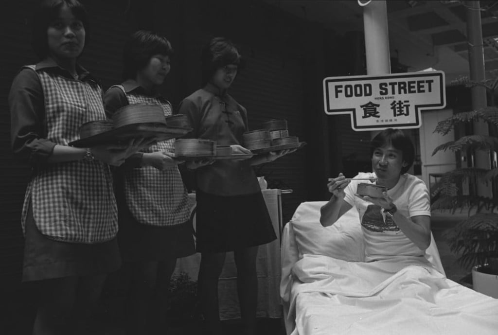 James Wong, winner of the 1978 ”’Fulfil Your Wildest Dream in Hong Kong’’ contest, enjoys breakfast on “Food Street”. The competition was sponsored by the Hong Kong Tourist Association and Cathay Pacific.