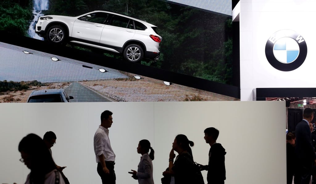 Visitors pass by a stand selling the long wheelbase BMW X1 xDrive25Li during Auto China 2016 auto show in Beijing April 25, 2016. The German firm is rumoured to be on the brink of announcing an all-electric vehicle joint venture with Great Wall Motor. Photo: Reuters