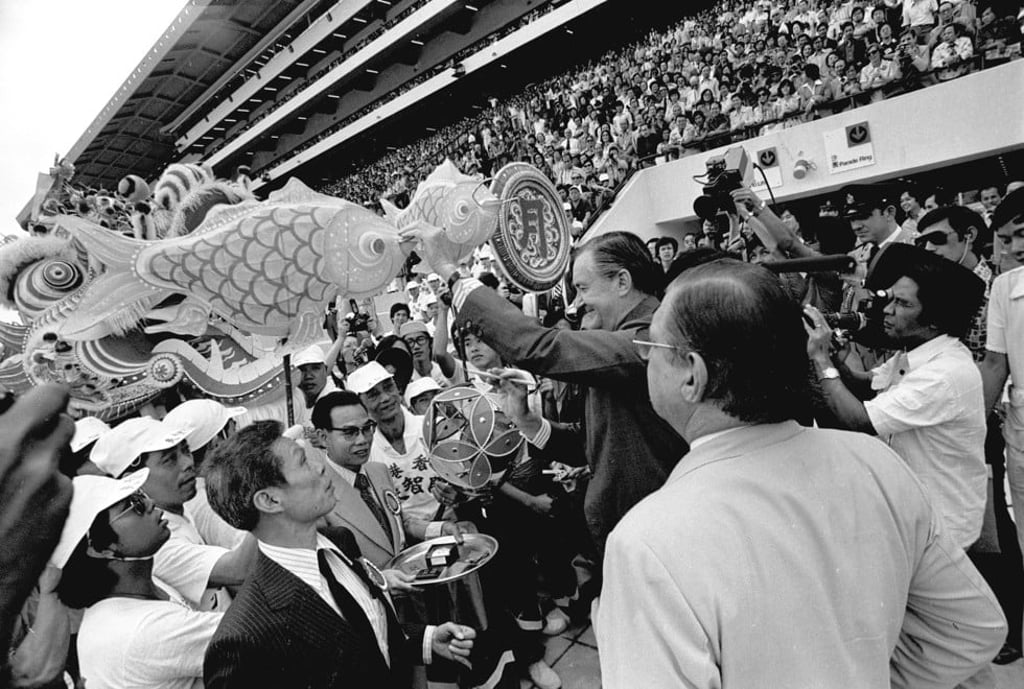Governor Sir Murray MacLehose dots the goldfish eyes at the opening ceremony of Sha Tin Racecourse.