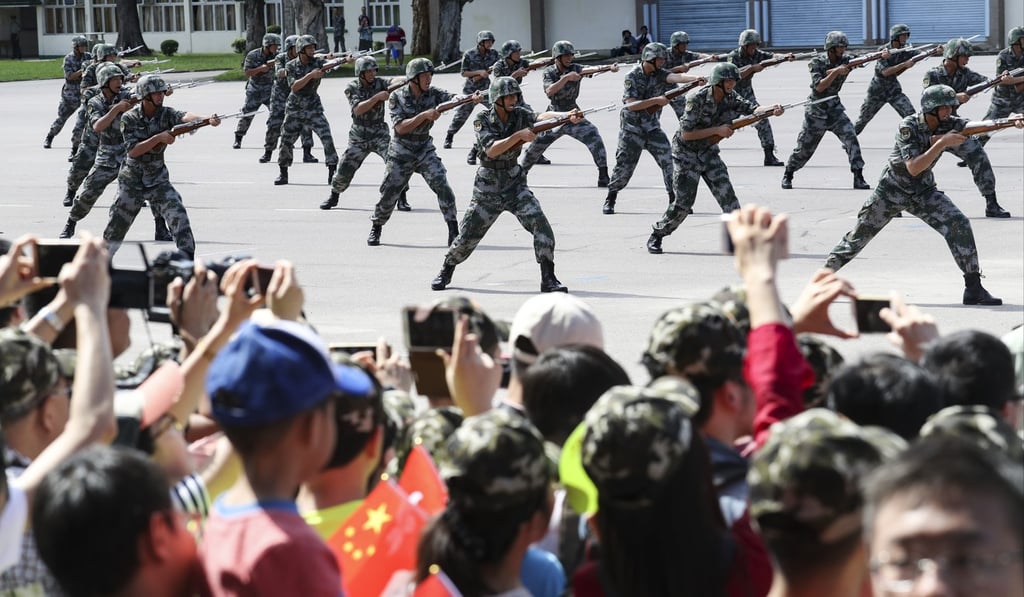 Visitors watch soldiers in action during an open day at the PLA barracks in San Wai, Hong Kong in July. Photo: Nora Tam
