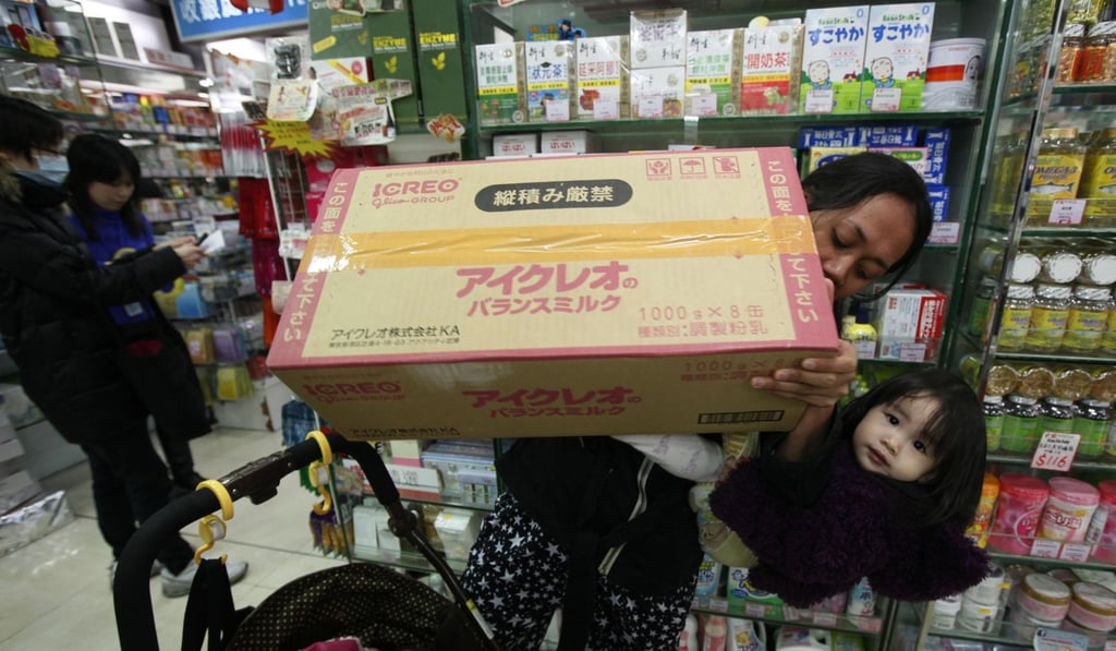 Customers queuing up to buy boxes of Japanese milk powder from a store in Hong Kong. Photo: AP