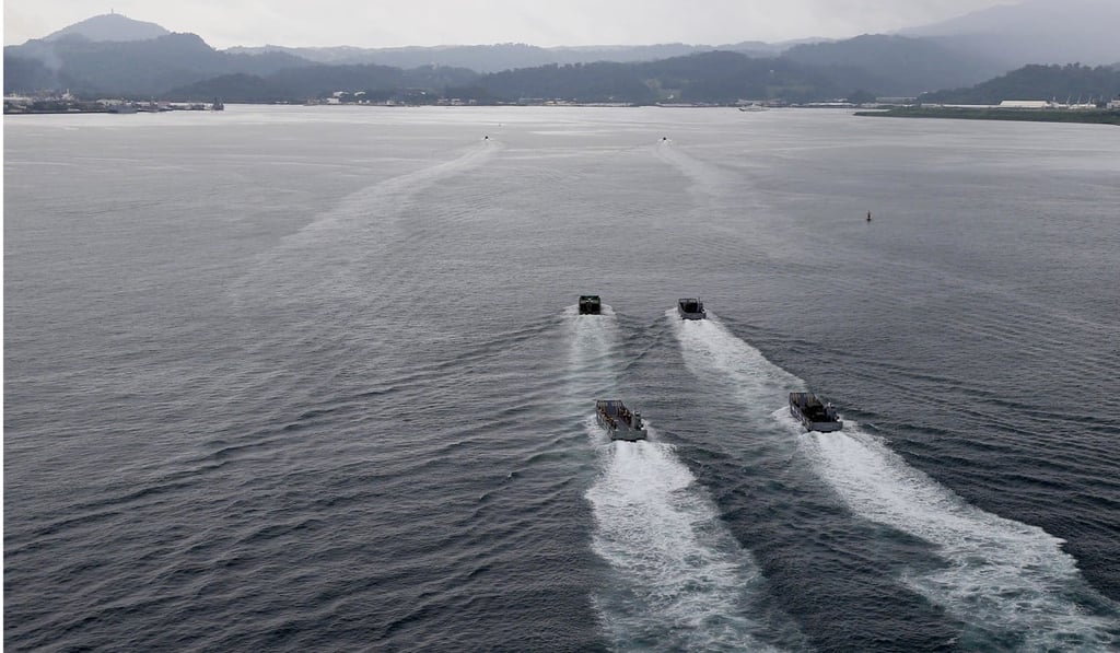 Landing crafts carrying Philippine marines and Australian troops off Subic Bay, north of Manila. Photo: AP