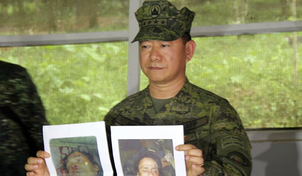 Philippine military chief General Eduardo Ano holds pictures of dead militant leaders during a press conference at a military camp in Marawi, southern Philippines. Photo: AP Philippine military chief General Eduardo Ano holds pictures of dead militant leaders during a press conference at a military camp in Marawi, southern Philippines. Photo: AP