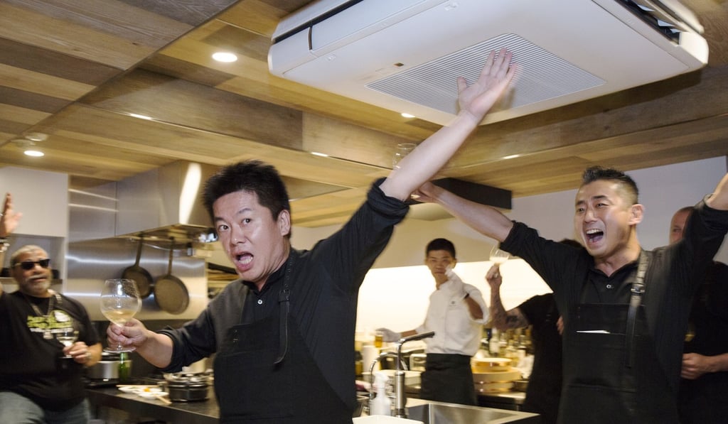 Takafumi Horie and Hisato Hamada raise their glasses for a toast at a Wagyumafia members-only restaurant in Tokyo.