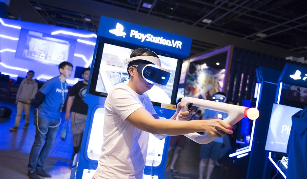 A visitor tries his hand at the latest VR games at the PlayStation booth.