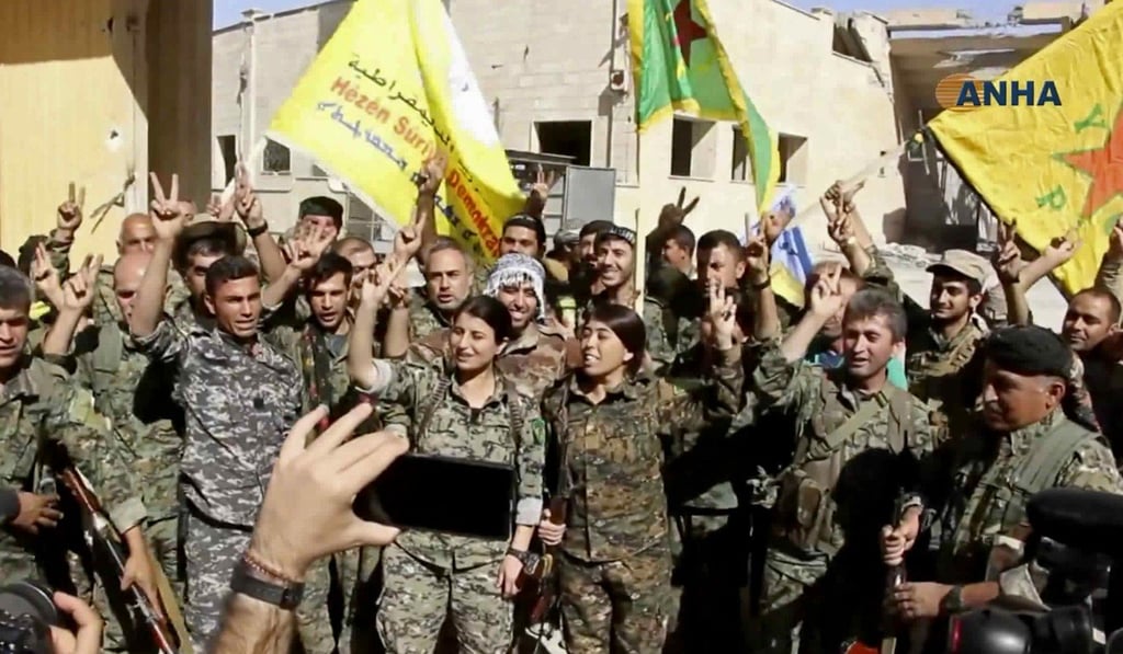 This frame grab from video released Tuesday shows fighters from the US-backed Syrian Democratic Forces (SDF) celebrating their victory in Raqqa. Photo: AP