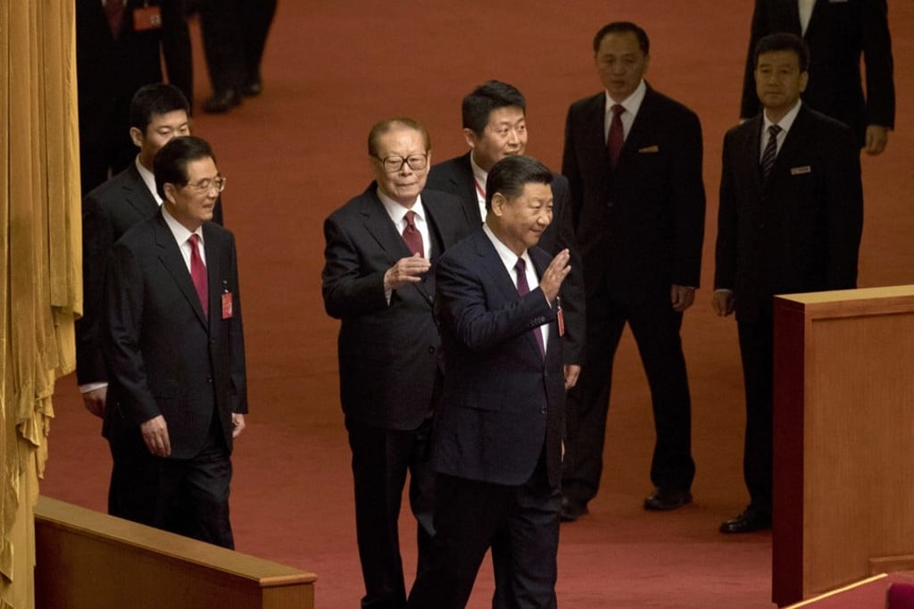 Chinese President Xi Jinping (centre) waves as he walks ahead of former Presidents Jiang Zemin (third from left) and Hu Jintao (second left) as they arrive for the opening ceremony of the 19th party congress. Photo: AP