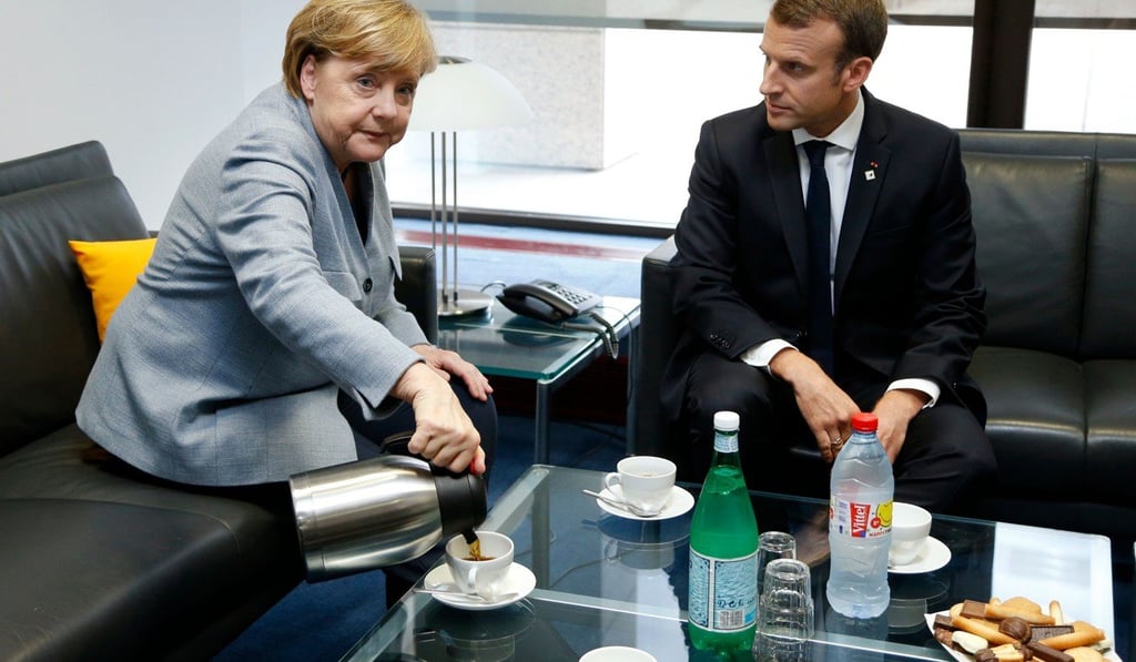 Merkel and Macron enjoying some coffee and biscuits during a bilateral meeting in Brussels on October 19, 2017. Photo: AFP