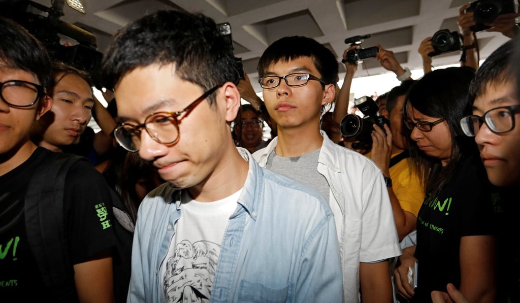 Student leaders Nathan Law and Joshua Wong walk into the Hong Kong High Court to face the verdict on charges relating to the 2014 Occupy Central protests, on August 17. Photo: Reuters