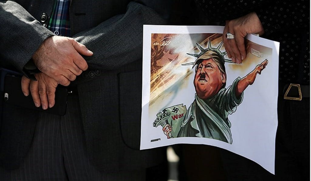 An Iranian student holds a caricature of US President Donald Trump during a protest against Trump’s refusal to certify the Iranian nuclear deal despite Tehran’s compliance. Photo: Handout via Reuters