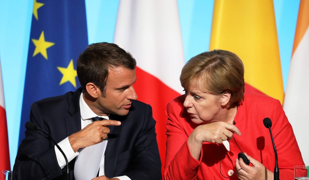 French President Emmanuel Macron and German Chancellor Angela Merkel attend a meeting with EU and African leaders in late August at the Elysee Palace in Paris. Photo: AFP