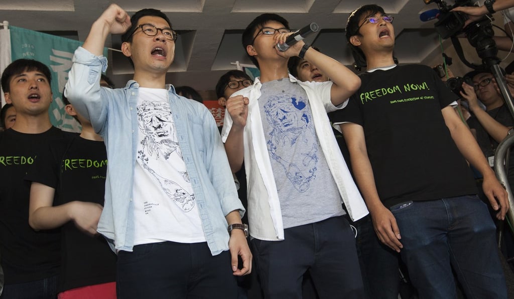 Student pro-democracy activists (from left) Nathan Law, Joshua Wong and Alex Chow speak to the media outside Hong Kong's High Court on August 17 this year, the day of their sentencing for unlawful assembly. Photo: EPA