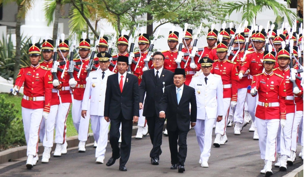 Anies Baswedan (front left wearing white) and his running mate, businessman Sandiaga Uno (front right wearing white) march with Indonesian President Joko Widodo (centre left), Vice-President Jusuf Kalla (centre right) and Minister of Internal Affairs Tjahjo Kumolo, to the Presidential palace for an inauguration ceremony in Jakarta. Photo: AFP Anies Baswedan (front left wearing white) and his running mate, businessman Sandiaga Uno (front right wearing white) march with Indonesian President Joko Widodo (centre left), Vice-President Jusuf Kalla (centre right) and Minister of Internal Affairs Tjahjo Kumolo, to the Presidential palace for an inauguration ceremony in Jakarta. Photo: AFP