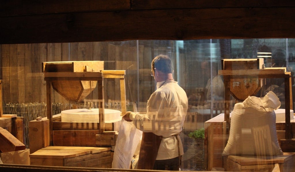 Mullixhiu’s traditional wooden mills grinds heirloom wheat in view of diners at the restaurant. Photo: Mullixhiu
