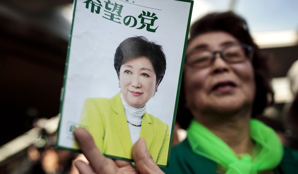 Supporters hold an election leaflet of Tokyo Governor and leader of the Party of Hope Yuriko Koike in the lead up to Sunday’s election. Photo: AFP