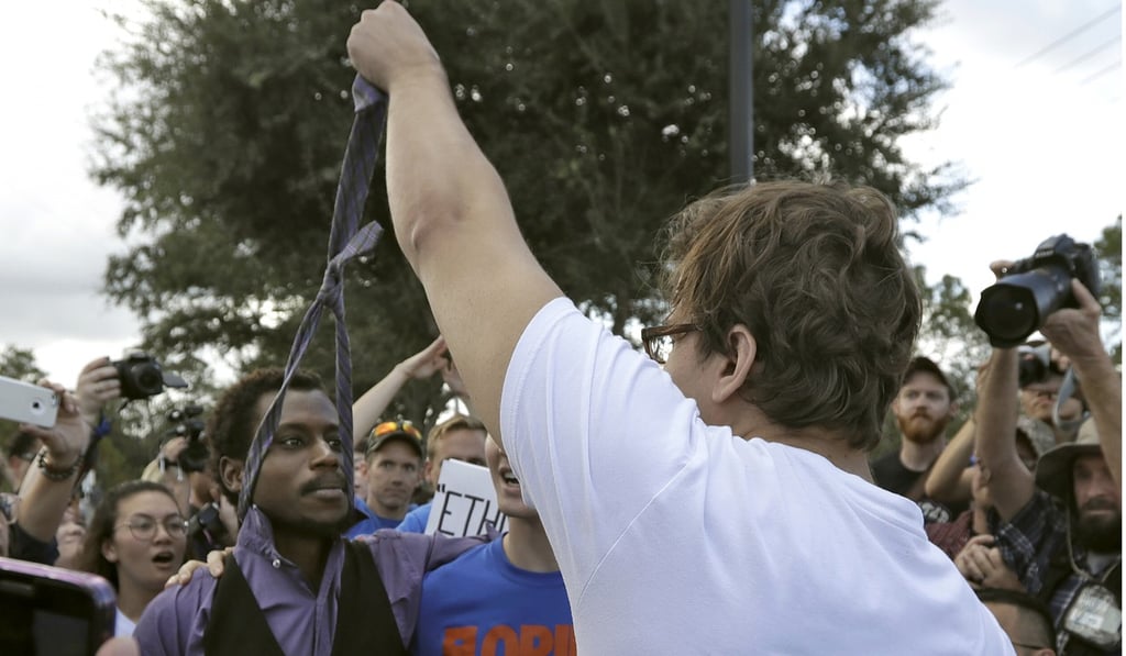 A supporter of white nationalist Richard Spencer grabs hold of a protester's tie during a clash outside the auditorium where Spencer was due to speak on Thursday. Photo: AP
