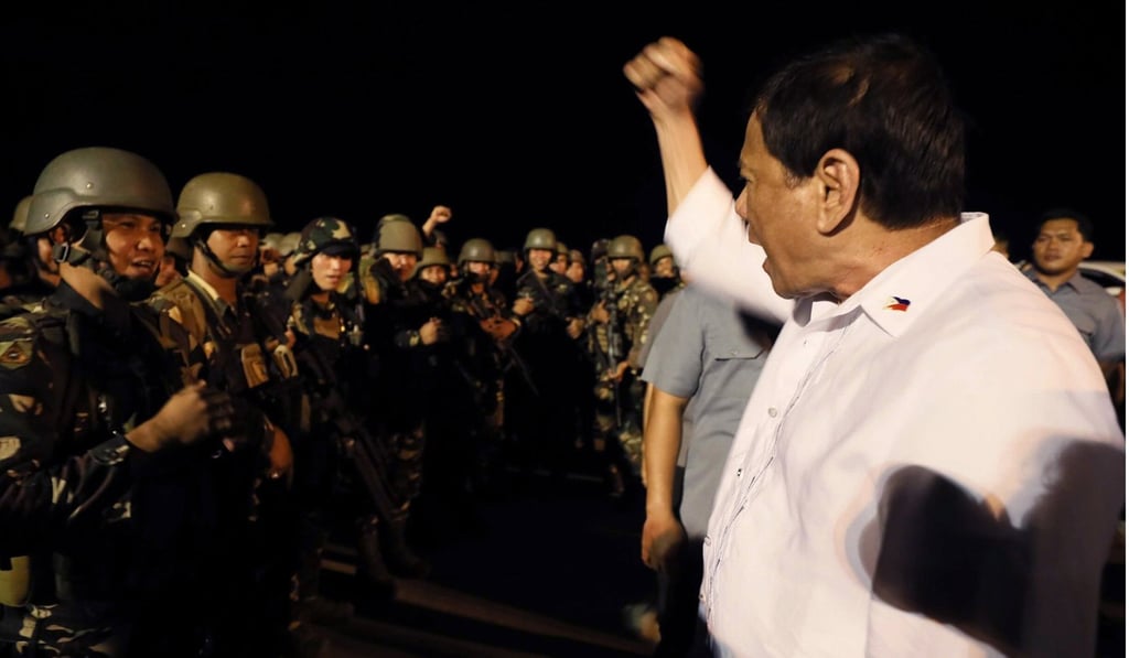 Duterte saluting soldiers at an airport in Cagayan de Oro. Photo: EPA