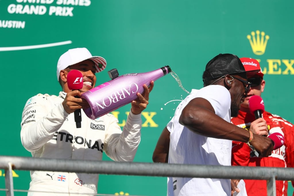 US Grand Prix winner Lewis Hamilton celebrates on the podium with Usain Bolt. Photo: AFP US Grand Prix winner Lewis Hamilton celebrates on the podium with Usain Bolt. Photo: AFP