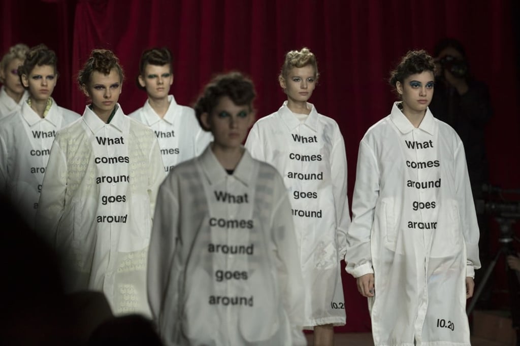 Sacai and Undercover models walk down the open-ended catwalk in pairs at mazon Fashion Week Tokyo.