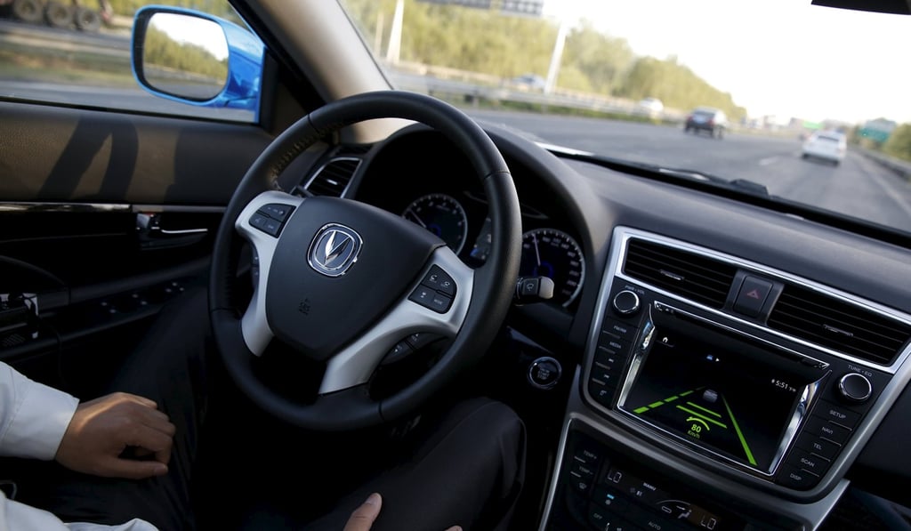 A development engineer at Changan Automobile sets an autonomous car on driverless mode during a test drive on a highway in Beijing in April 2016. Photo: Reuters