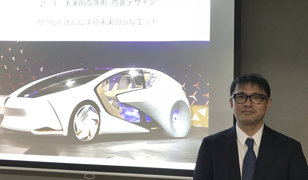 Toyota Motor Corp manager Makoto Okabe stands in front of an image of the concept car “TOYOTA Concept-i” series. The use of artificial intelligence means cars may get to know drivers as human beings by analysing their facial expressions, driving habits and social media use. Photo: AP Toyota Motor Corp manager Makoto Okabe stands in front of an image of the concept car “TOYOTA Concept-i” series. The use of artificial intelligence means cars may get to know drivers as human beings by analysing their facial expressions, driving habits and social media use. Photo: AP