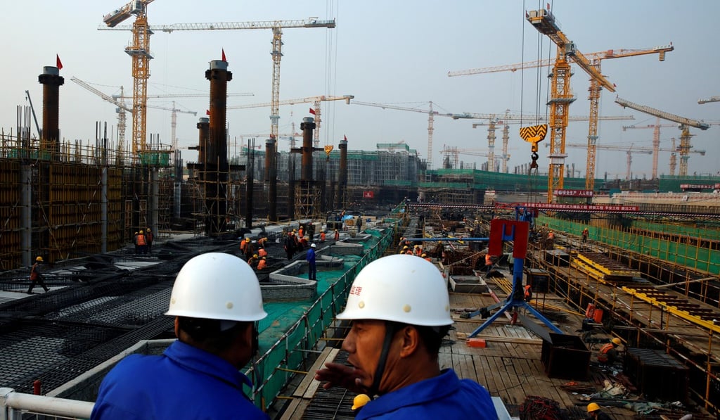 Workers survey the construction site for the terminal at Beijing’s new airport in the capital’s southern Daxing district. Photo: Reuters