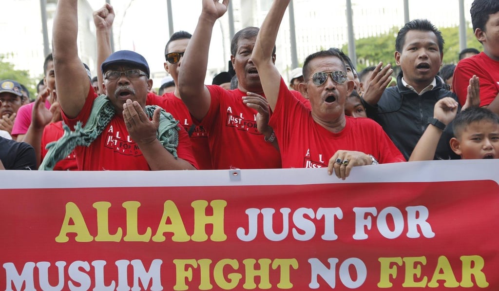 Muslim demonstrators chant slogans outside Malaysia's Court of Appeal in Putrajaya on October 14 after a Malaysian court ruled that a Christian newspaper could not use the word “Allah” to refer to God. Photo: Reuters