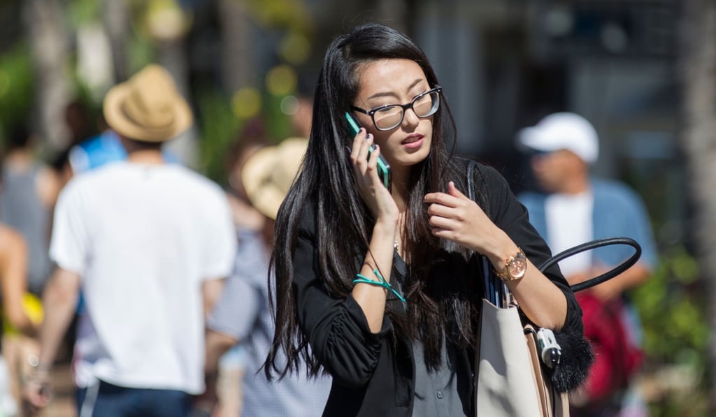 A pedestrian crosses Kalakaua Avenue talking on her mobile phone October 24, 2017 in Honolulu, Hawaii. Photo: Agence France-Presse A pedestrian crosses Kalakaua Avenue talking on her mobile phone October 24, 2017 in Honolulu, Hawaii. Photo: Agence France-Presse