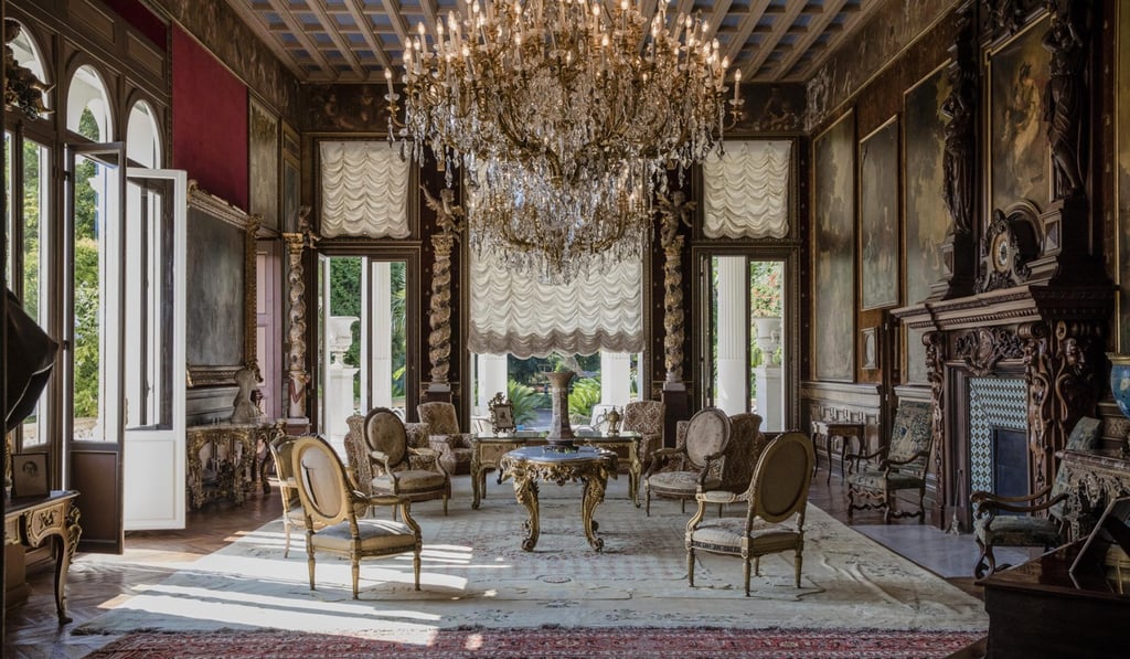 Antique furniture, chandeliers as 19th century portraits adorn the walls of a sitting room inside the Villa Les Cedres. Photo: Bloomberg