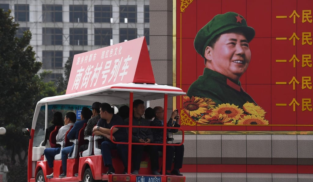 A tourist cart passes a billboard image of late communist leader Mao Zedong in China’s Henan province. Photo: AFP