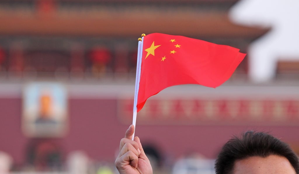 A tourist at the national-flag raising ceremony at Tiananmen Square. Photo: Simon Song