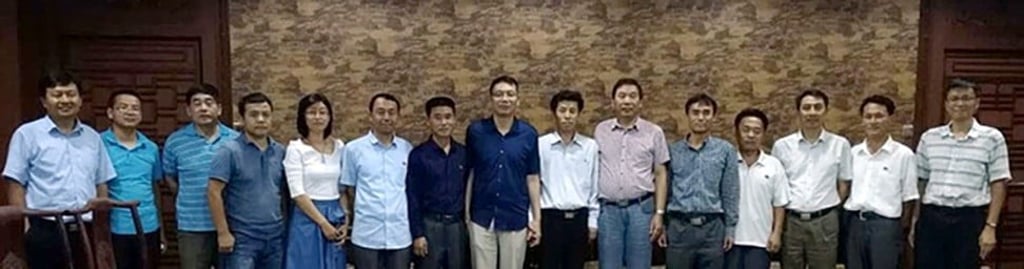 The North Korean and Chinese delegations at the Chinese Academy of Science’s Institute of Geology and Geophysics in Beijing last month. The North Korean members have a small pin on their chest. Photo: Handout The North Korean and Chinese delegations at the Chinese Academy of Science’s Institute of Geology and Geophysics in Beijing last month. The North Korean members have a small pin on their chest. Photo: Handout