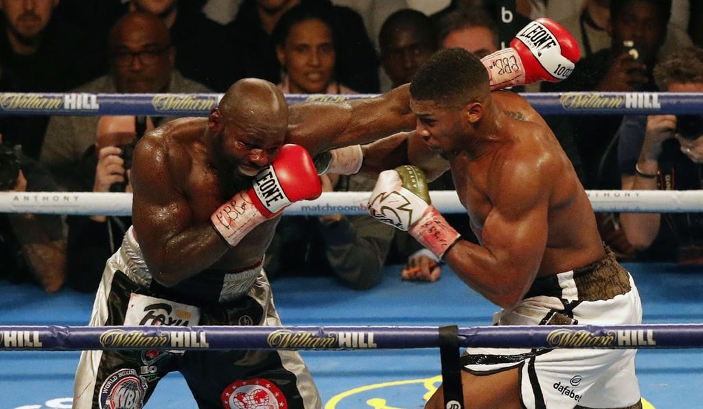 Carlos Takam (left) exchanges blows with s Anthony Joshua at the Principality Stadium in Cardiff. Photo: AFP