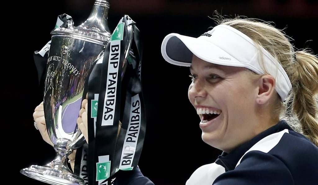 Caroline Wozniacki holds the Billie Jean King trophy after defeating Venus Williams. Photo: EPA
