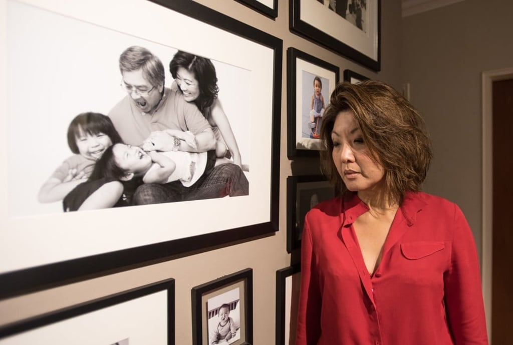 Wee next to a family portrait of her with her husband, Choi Chi-man, son Luca and daughter Zoe. Picture: AFP