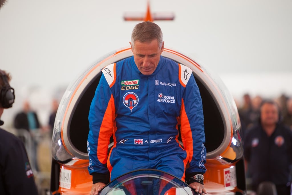 Royal Air Force fighter pilot Andy Green climbs into the cockpit of Bloodhound Supersonic Car before the start of the testing.