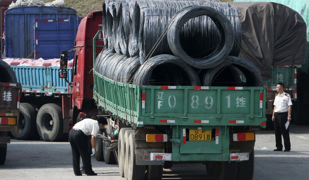 Chinese customs officers inspect trucks loaded with goods going to and from North Korea in Dandong. Photo: AP