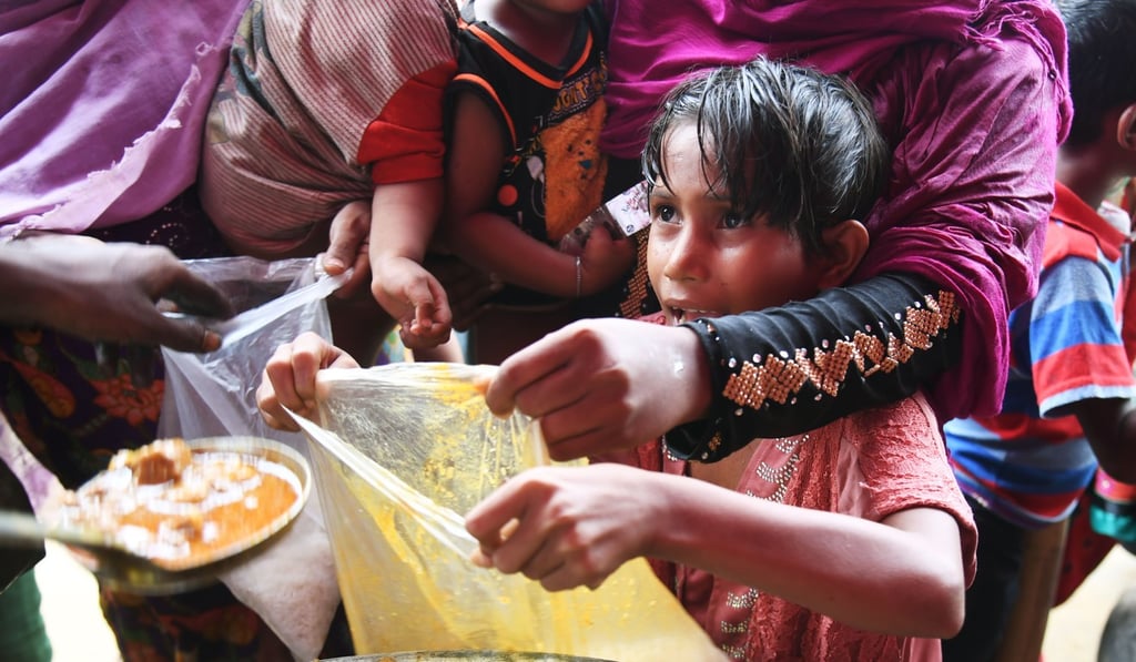 Rohingya refugees receive food distributed by a Turkish aid agency at a refugee camp in the Bangladeshi region of Ukhia on Monday. Photo: AFP Rohingya refugees receive food distributed by a Turkish aid agency at a refugee camp in the Bangladeshi region of Ukhia on Monday. Photo: AFP