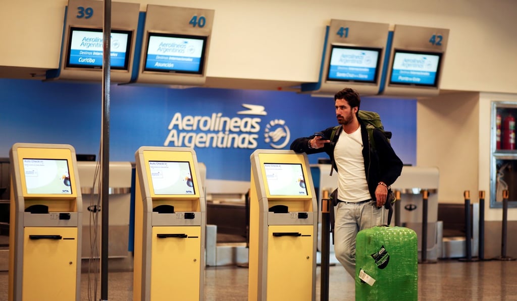 A passenger waits in front of empty counters of Argentina's flagship air carrier Aerolineas Argentinas. Photo: Reuters
