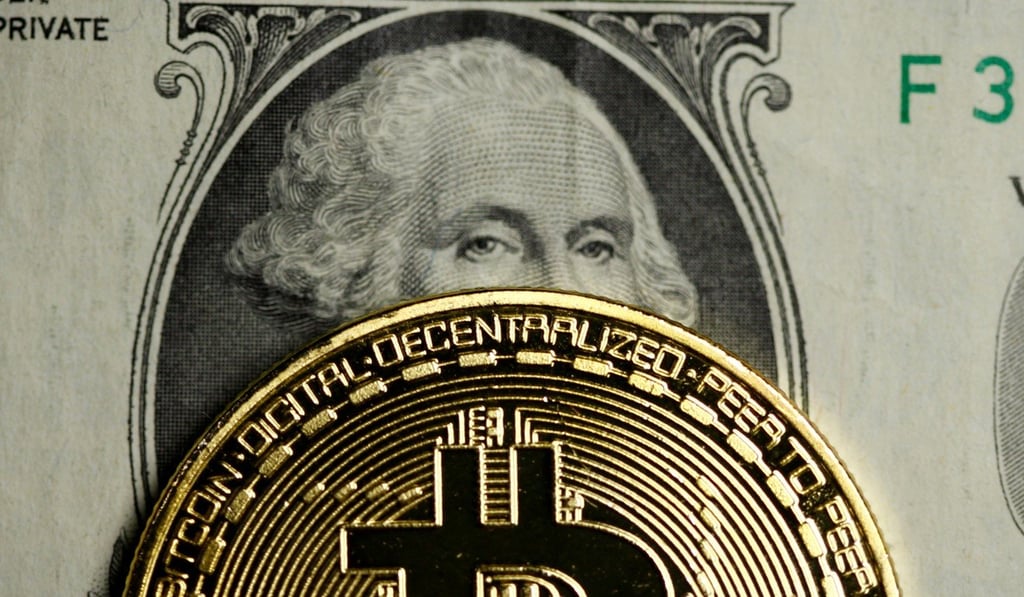 A Bitcoin and dollar note are seen in this illustration picture. Photo: Reuters
