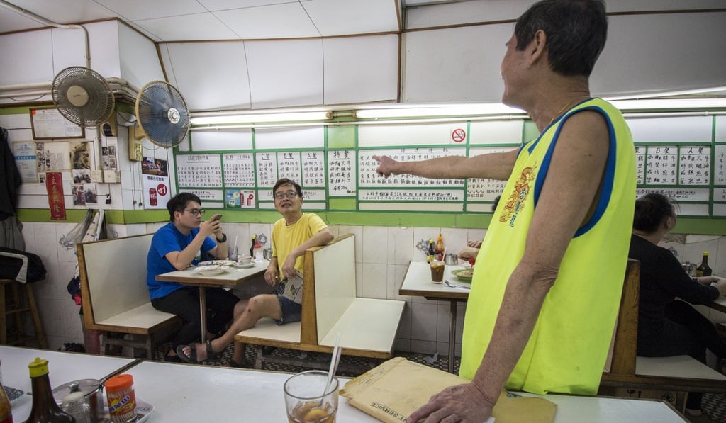 Bo Fuk restaurant owner Chow Chi-soon chats with regular customers. Photo: Chris DeWolf