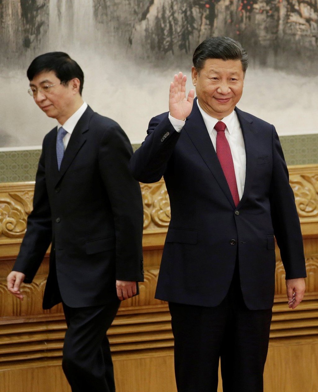 New Politburo Standing Committee member Wang Huning walks behind President Xi Jinping as they and other new committee members meet the press at the Great Hall of the People in Beijing, on October 25. Photo: Reuters