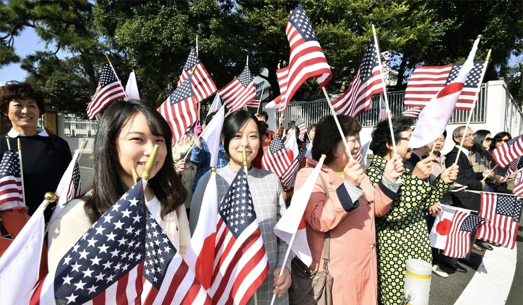 A supportive crowd waits outside the State Guest House in Tokyo on Monday, ahead of US President Donald Trump’s arrival. Photo: Kyodo