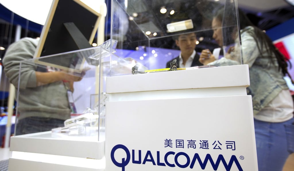 Visitors look at a display booth for Qualcomm at the Global Mobile Internet Conference (GMIC) in Beijing. Broadcom is making an unsolicited, US$130 billion offer for rival chip maker Qualcomm, the largest deal ever in the tech industry that will face intense regulatory scrutiny. Photo: AP