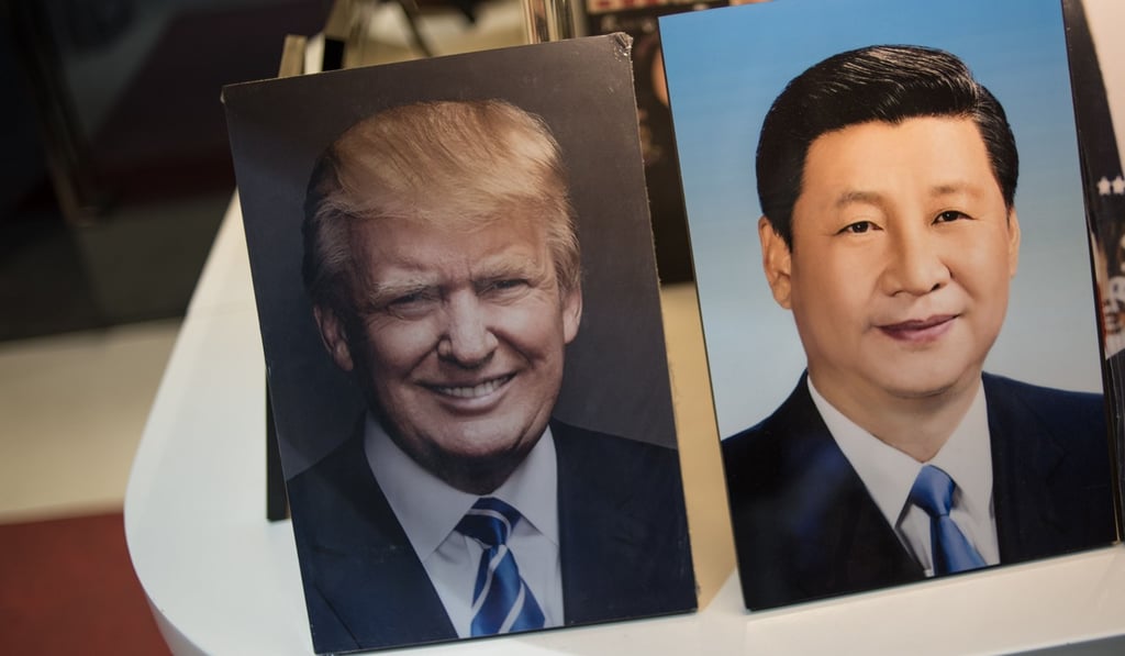 Photographs of Chinese President Xi Jinping (right) and US President Donald Trump are seen on display in a photo shop in Beijing on November 6, 2017. Photo: AFP