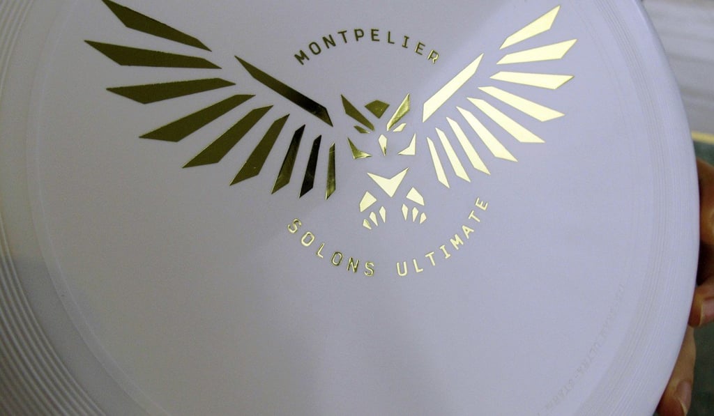 An official ultimate disc is held by a Montpelier High School student outside the school in Vermont. Photo: AP