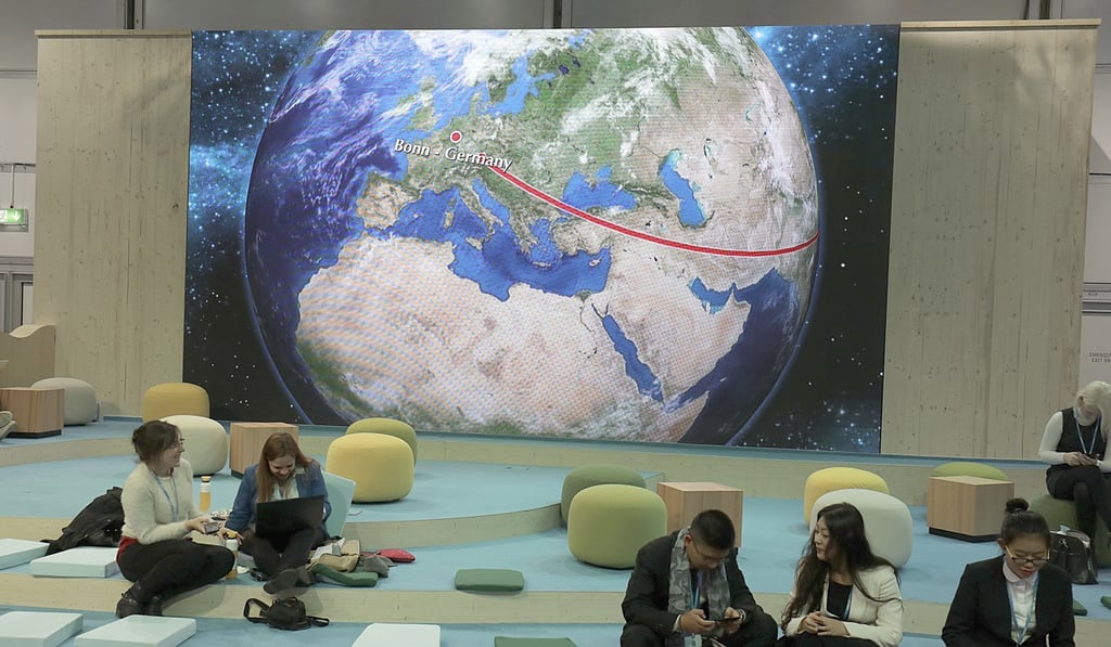 Participants at the World Climate Conference working in front of the depiction of a globe in Bonn, Germany. Photo: DPA via AP Participants at the World Climate Conference working in front of the depiction of a globe in Bonn, Germany. Photo: DPA via AP